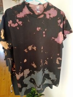 Hello and welcome to my store!  This is a Gildan brand 100% cotton T-Shirt which I reverse dyed using bleach (all bleach is then removed by washing) This shirt style is unisex and the brand is from the US so the sizes are quite large and oversized. This is the perfect addition to any wardrobe, super comfy and looks great all year round. It would make a great unisex gift for people of all ages! Care instructions I would recommend washing on a cool wash with like colours.  Tie dye, Tiedye, t-shirt, tie dye shirt, tie dye tee, handmade tie dye shirt, hand dyed tee, tie dye t-shirt,  handmade, tee shirt, t shirt, shirt, cotton, fiber reactive dye, Adult Shirt, Reverse tie dye, Cotton Tie Dye Tops With Natural Dye, Tie Dye Cotton Top With Natural Dye, Hand Dyed Cotton Tops In Washed Black, Tie Dye T-shirt With Natural Dye And Crew Neck, Hand Dyed Faded Cotton Tops, Cotton T-shirt With Natural Dye And Short Sleeves, Hand Dyed Washed Black Cotton Tops, Acid Wash Crew Neck T-shirt With Natural Dye, Crew Neck Cotton T-shirt With Natural Dye