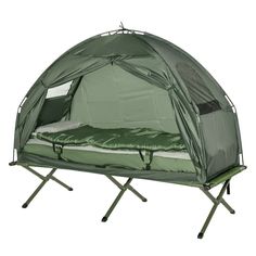 a green tent with a bed in it on top of a white floor and black legs