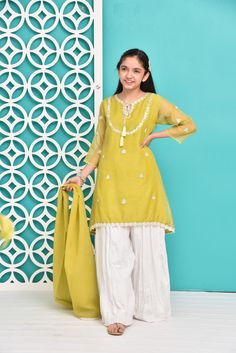 Up the style ante of your little one by giving this feminine traditional look a feisty twist.Description : Kameez (Shirt) : Shirt with Embroidery Work and Lining Inside. Shalwar (Pants) : White crush Gharara. Dupatta (Scarf) : Embellished Dupatta. Gharara Dress, Shirt With Embroidery, Eid Dresses, Green Girl, Pants White, Shalwar Kameez, Star Girl, Embroidery Work, Beautiful Embroidery