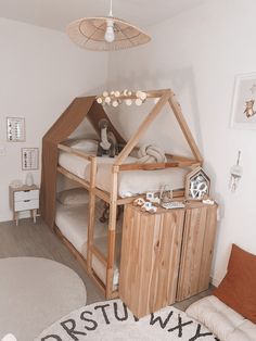 a child's bedroom with a wooden bed and white rugs on the floor