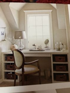 an open book showing a desk and chair in a room with white walls, windows, and drawers