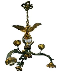 a chandelier with an eagle on the top and four lights hanging from it