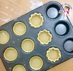 an uncooked muffin pan with nine cupcakes in it on a table