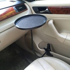 the interior of a car with a table in the passenger side seat and an air freshener dispenser attached to it