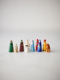 a group of small ceramic objects sitting on top of a white table next to each other