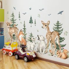 a child's room with deer wallpaper and toys