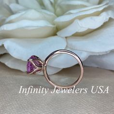 "This ring is a round cut lab created pink sapphire solitaire in 14k rose gold #6465 -Approximate total carat weight: 2.70ctw. diamond equivalent -Center Stone Size: approx. 2.70ct diamond equivalent -Center Stone Shape: round cut / 9 MM -Gem Type: lab created pink sapphire -Stone Clarity: VS2 -Stone Color: Medium Pink -Moh's Scale: 9 hardness -Metal Type and Purity: 14k rose gold -Setting: classic Tulip 4 Prong Setting -Stock Ring Size: 6 -Country of Manufacturing: USA (Michigan) For customizat Pink Gold Round Ruby Ring With Prong Setting, Pink Gold Ruby Ring With Prong Setting, Pink Brilliant Cut Amethyst Wedding Ring, Wedding Pink Brilliant Cut Amethyst Ring, Pink Brilliant Cut Sapphire Ring As Gift, Pink Brilliant Cut Sapphire Ring Gift, Fine Jewelry Pink Gold Sapphire Ring With Pink Sapphire, Pink Round Cut Ruby Ring For Anniversary, Pink Sapphire Round Cut Ring