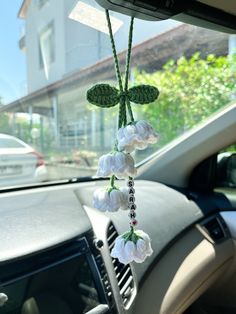 the interior of a car with flowers hanging from it