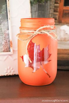 an orange mason jar sitting on top of a table