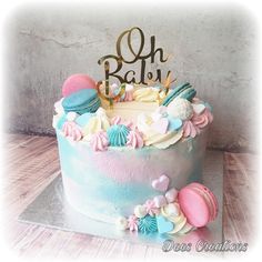 a birthday cake decorated with seashells and the word oh baby on top