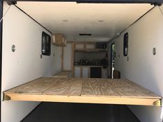 the inside of an enclosed trailer with wood flooring