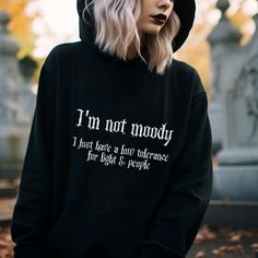 Gothic Hoodie with a funny Goth Quote on the front: I'm not moody, I just have a low tolerance for light & people. This black Spooky Hoodie creates a dark gothic and witchy style. Fun for a Halloween lover or a sarcastic person. ❗️❗️❗️Please be aware that the  Hoodie is an Unisex Cut and may be oversized.  Please check the size charts to measure yourself to be sure you will receive a good sized item. 🖤 The position, colors and size of the print may differ slightly from the illustrations. SHIPPI Emo Letter Print Sweatshirt For Fall, Hooded Hoodie With Letter Print For Alternative Fashion, Winter Emo Sweatshirt With Letter Print, Fall Hoodie With Letter Print For Alternative Fashion, Alternative Hoodie With Letter Print For Fall, Alternative Letter Print Hoodie For Fall, Alternative Style Halloween Hoodie With Letter Print, Alternative Halloween Hoodie With Letter Print, Witchy Clothes Aesthetic