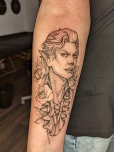 a woman's face with flowers on her arm