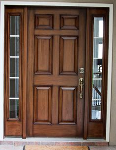 the front door is made of wood and has two sidelights on each side with glass panels