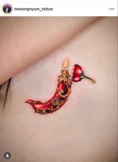 a woman's stomach with a tattoo on it that has a candle in the shape of a flower