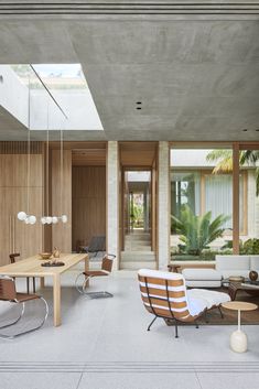 a living room filled with furniture and lots of windows