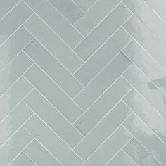 a white and grey herringbone tile wall