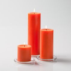 three orange candles sitting next to each other