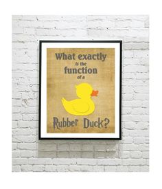 a yellow rubber ducky poster hanging on a white brick wall with the words what exactly function is rubber duck?