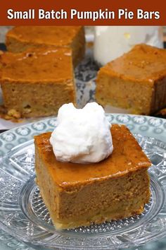 small batch pumpkin pie bars on a plate with whipped cream in the middle and one slice missing