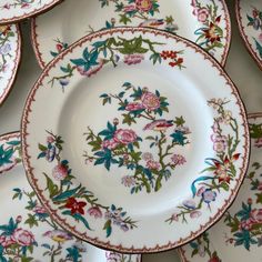 a bunch of plates that have flowers on them