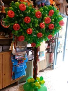 a balloon tree with red and green balloons on it