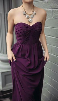 a woman in a strapless purple dress