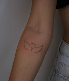 a woman's arm with a tattoo design on the left side of her arm