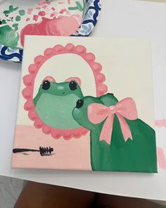 a painting of a frog with a pink bow on it's head is shown