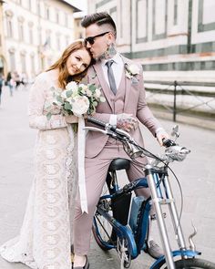 a bride and groom are sitting on a scooter