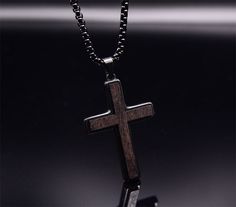 Add a touch of sophistication to your ensemble with our Ebony Wood Cross Necklace for Men. Handmade with care, this black stainless steel Christian pendant features a Real Ebony Wood pendant on a 24-inch chain. It's a symbol of faith and fashion. Highlights: UNUSUAL DESIGN: Wooden Cross Necklace for men using real natural ebony wood with High quality stainless steel. It not only retains the natural essence of the wood cross necklace but also takes into account the strong protection of stainless Black Stainless Steel Cross Pendant Necklace, Black Stainless Steel Necklace With Cross Pendant, Black Stainless Steel Cross Pendant Jewelry, Black Stainless Steel Necklace, Cross Jewelry Necklace, Wooden Watches For Men, Mens Cross Necklace, Mens Crosses, Wooden Watch