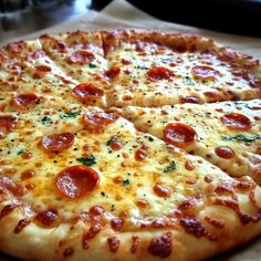 a pepperoni pizza sitting on top of a table