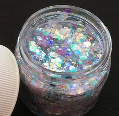 there is a jar of glitter next to the container