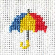 the cross stitch pattern has an umbrella on it