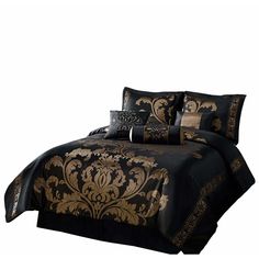 a bed with black and gold comforters on it