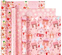 pink wrapping paper with houses and snowflakes on the top, in three different patterns