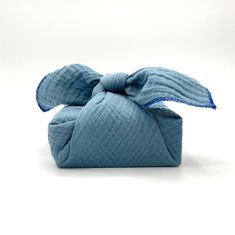 a small blue bag with a bow on it