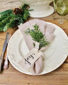 a place setting with pine cones and napkins