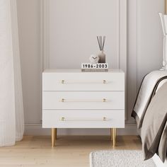 a bedroom with white furniture and wood floors