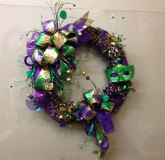 a purple and green wreath hanging on the wall