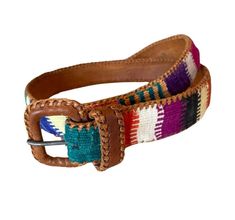 Unique leather Southwestern-style belt features woven colorful fabric detail. The belt measures approximately "34 inches buckle to and features 5 belt holes. The leather has a braided leather edge wrapped on the top and the bottom. Color-block colorful woven pattern is very decorative. Farthest hole at 32".  This belt is in good condition with light wear that adds to Vintage aesthetic. Very simple buckle is wrapped in leather. Folk Style Multicolor Embroidered Belt, Handmade Bohemian Multicolor Belt, Adjustable Multicolor Leather Belts, Artisan Multicolor Fabric Belt, Multicolor Embroidered Leather Belt, Woven Belt, Southwestern Style, Suspender Belt, Vintage Aesthetic