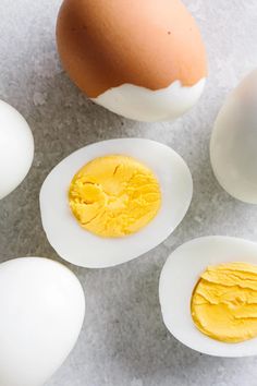 three eggs and one egg yolk on a table