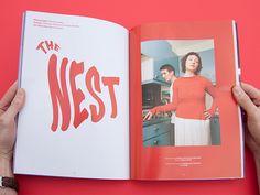 a person holding an open book with the title'the nest'in red on it