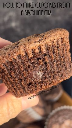 a hand holding a chocolate cupcake from a brownie mix