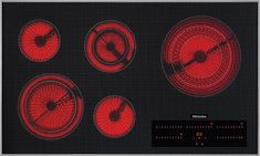 an electric stove with four different knobs on the front and two red buttons on the back