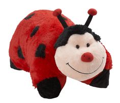 a ladybug stuffed animal laying on its side