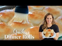 a woman holding a plate of bread rolls