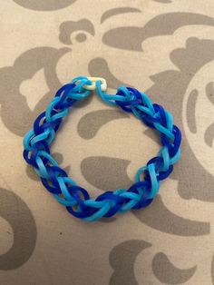 a blue and white bracelet sitting on top of a table