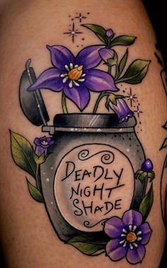 a tattoo with purple flowers in a jar and the words deadly night shade written on it