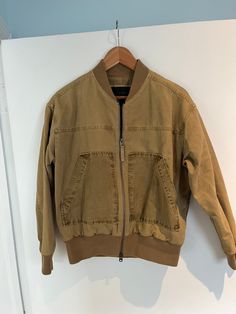 This vintage J.Crew bomber jacket in tan khaki offers a classic workwear-inspired style with a modern twist. Crafted from durable cotton, it features a zip front, ribbed cuffs, and a structured collar for a timeless, functional look. The jacket is lightweight yet sturdy, perfect for layering during cooler months. In size small, this versatile piece combines comfort with utility, making it an essential for any wardrobe. Urban Brown Utility Jacket For Streetwear, Brown Utility Jacket For Streetwear, Brown Utility Jacket With Patch Pockets For Streetwear, Brown Military Utility Jacket For Workwear, Urban Cargo Outerwear For Work, Urban Cargo Style Outerwear For Workwear, Urban Cargo Style Khaki Outerwear, Khaki Outerwear With Ribbed Cuffs For Work, Khaki Cargo Style Outerwear For Work